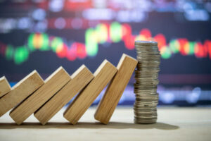 Money coins heap still balance and stop the falling domino, financial stability concept,stock market concept.